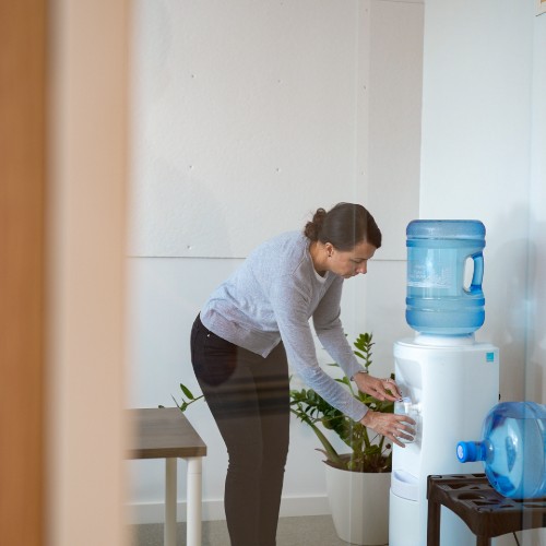 getting water from a white business water cooler