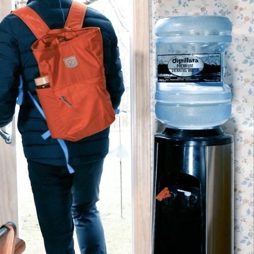Premium Drinking water 5 gallon jug on water cooler in home
