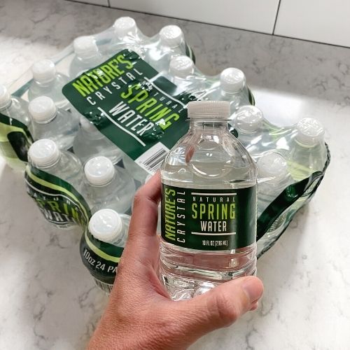 10 ounce natures crystal spring water bottles on counter