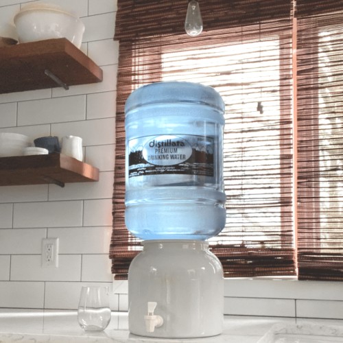 front view of ceramic crock water dispenser with Distillata Water bottle