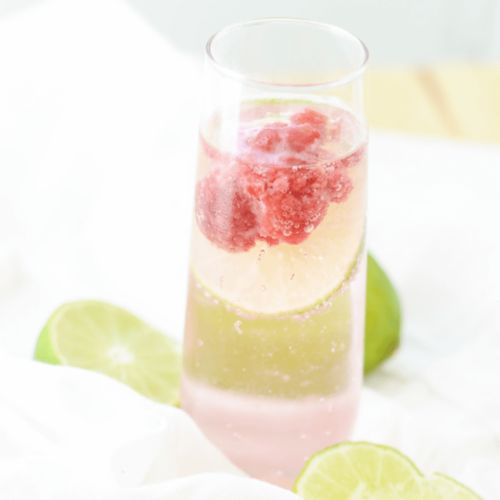 raspberry lime sparkler in champagne glass