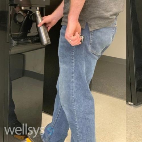 man dispensing water hand free from wellsys water filter