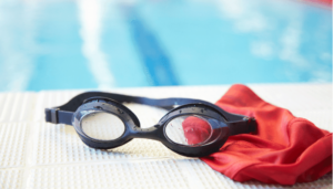 black goggles sitting on the side of a swimming pool