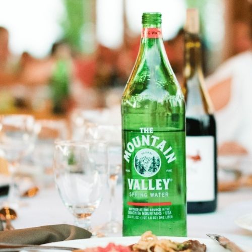 mountain valley glass water bottle on a table setting at a special event