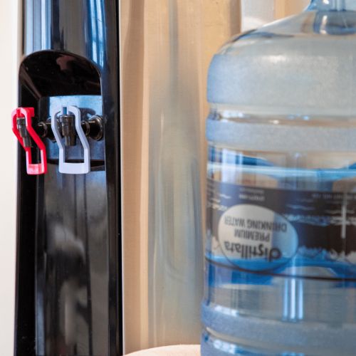 5 gallon water jug in front of water dispenser