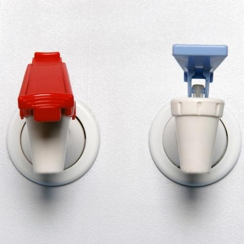 red and blue water dispenser spigots on a white cooler