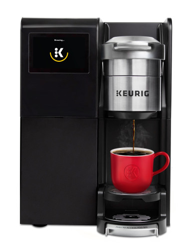 commercial keurig coffee brewer with red mug
