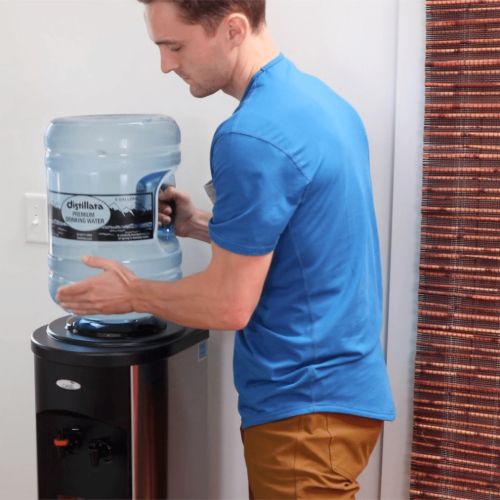 putting a 5 gallon water bottle on a stainless steel water cooler at home