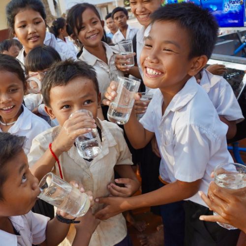 children drinking water from Planet Water filtration system