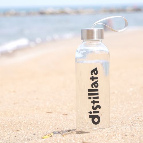Distillata glass reusable water bottle on beach in Lorain, Oh