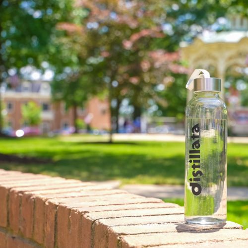 clear glass bottle of distillata spring water